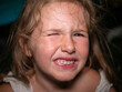 Headshot of a cute little girl grimacing