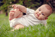 Child smiling and looking at camera outdoors in sunlight. Baby's morning, baby products concept.