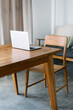 © Dreamwood Photography/Stocksy - Laptop on wooden table in apartment
