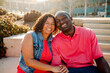© Erin Brant/Stocksy - Happy Black couple on steps outdoors