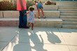 © Erin Brant/Stocksy - Dad with girls climbing outdoor steps