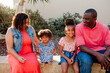 © Erin Brant/Stocksy - Beautiful family sitting outdoors
