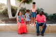 © Erin Brant/Stocksy - Joyful parents sitting outdoors with girls