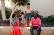 © Erin Brant/Stocksy - Smiling parents with daughters outside