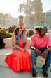 © Erin Brant/Stocksy - Laughing family outdoors on steps