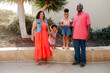 © Erin Brant/Stocksy - Girls standing on ledge between parents