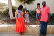 © Erin Brant/Stocksy - Sweet girls standing on ledge between parents