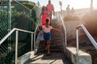 © Erin Brant/Stocksy - Family walking down outdoor stairway