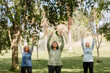 © McKinsey Jordan/Stocksy - Three Older Women Practice Yoga in the Park