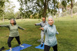 © McKinsey Jordan/Stocksy - Three Seniors Practice Warrior Two During Yoga Session