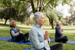 © McKinsey Jordan/Stocksy - Senior Friends Take a Moment to Meditate in the Park