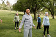 © McKinsey Jordan/Stocksy - Seniors Stand Tall in Mountain Pose During Yoga