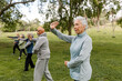 © McKinsey Jordan/Stocksy - Senior Workout Group Meet for a Session in the Park
