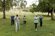 © McKinsey Jordan/Stocksy - Senior Yoga Group Meets in the Park for a Workout