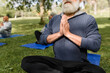 © McKinsey Jordan/Stocksy - Man Holds Hands in Prayer During Meditation in the Park