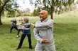 © McKinsey Jordan/Stocksy - Group of Seniors Work Out With Martial Arts