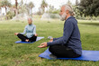 © McKinsey Jordan/Stocksy - Man and Woman Take a Moment to Meditate in the Park