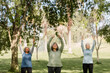 © McKinsey Jordan/Stocksy - Three Woman Stretch While Hanging Out in the Park
