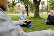 © McKinsey Jordan/Stocksy - Seniors Sit in Meditation While at the Park