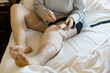 © Holly Clark/Stocksy - Woman wraps bandage around leg