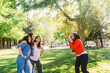 © ByLorena/Stocksy - Happy girlfriends taking selfie on photo camera in park
