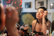 Emotionless Informal Woman Brushing Eyebrows Against Vanity Tabl