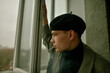 © Anna Artemenko/Stocksy - portrait of a young guy in a black beret