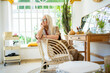 © Eloisa Ramos/Stocksy - Thoughtful senior woman relaxing at boho home