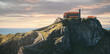 © David Prado/Stocksy - Rocky island San Juan de Gaztelugatxe against sunset sky aerial view