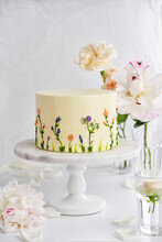 Delicious Wedding Cake On Stand On Table With Flowers
