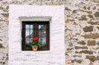 © Alexandra Bergam/Stocksy - Countryside house window with flower