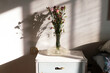 © Alessandra Desole/Stocksy - flowers bouquet on a vintage bedside table
