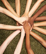 © Trinette Reed/Stocksy - Group of diverse women's hands connected together