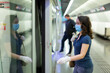 © JackF - Woman in personal protective equipment is standing on platform and running into train