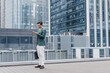 © Heng Yu/Stocksy - A man standing in front of city buildings
