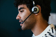 Hispanic man with headset speaking with client