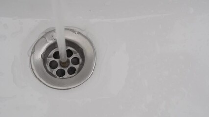 Wall Mural - Running tap water in the sink down the drain hole in HD