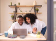 © Miquel Llonch/Stocksy - Smiling Black couple in office.