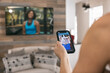 © Sean Locke/Stocksy - Home: Woman Uses Phone App During Streaming Workout Class