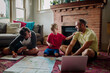 © Erin Brant/Stocksy - Dad laughs with sons while planning trip