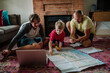 © Erin Brant/Stocksy - Brothers and dad looking at map