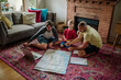 © Erin Brant/Stocksy - Trip planning by father and sons