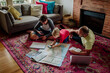 © Erin Brant/Stocksy - Father and sons planning trip