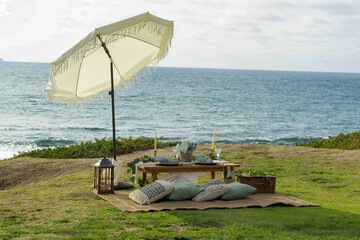 Wall Mural - Natural view of a picnic set up near coast at summertime