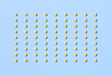 Round Yellow Pills On Blue Background
