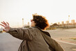 © Alba Vitta/Stocksy - Young woman having fun outdoors running on street