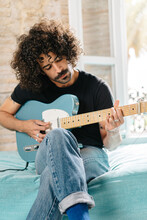 Musician Playing Electric Guitar At Home