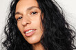© Anna Tabakova/Stocksy - Beautiful hispanic model smiling