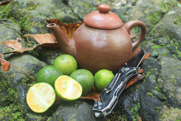 Wall Mural - a traditional teapot and cup that is unique from Indonesia because it is made of clay, to brew a healthy & fresh lemon drink.