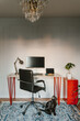 © Dima Sikorski/Stocksy - workplace with red furniture and a cat